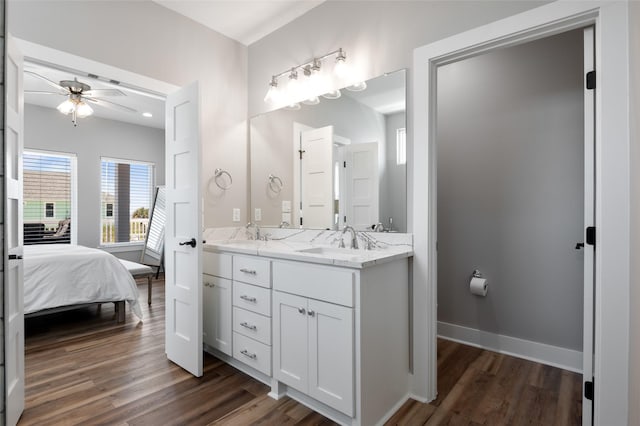 bathroom with hardwood / wood-style floors, ceiling fan, and vanity