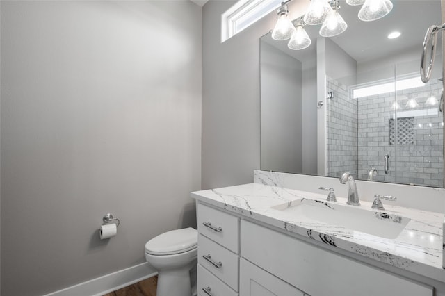 bathroom with hardwood / wood-style flooring, vanity, toilet, and a shower with shower door