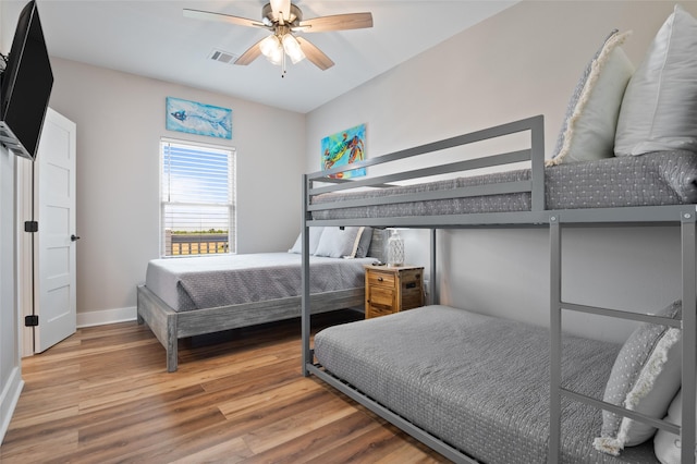 bedroom with ceiling fan and hardwood / wood-style floors