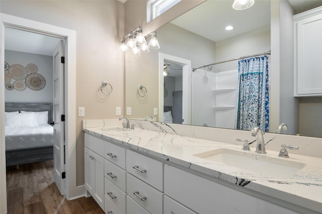 bathroom with a shower with curtain, ceiling fan, vanity, and hardwood / wood-style flooring