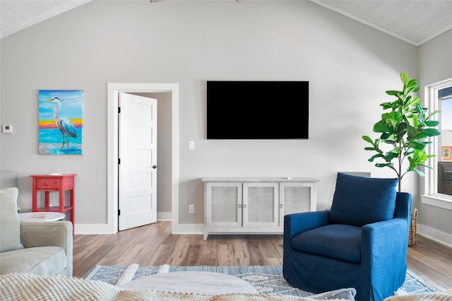 living room with crown molding, high vaulted ceiling, and light hardwood / wood-style floors