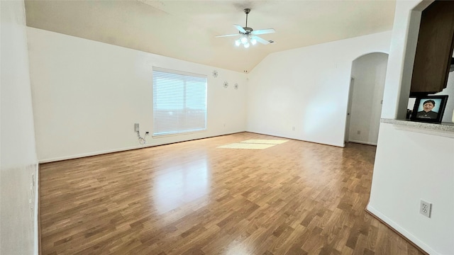 empty room featuring vaulted ceiling, ceiling fan, and hardwood / wood-style flooring