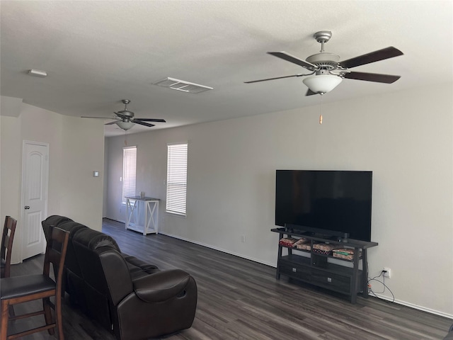 living room with ceiling fan and dark hardwood / wood-style floors