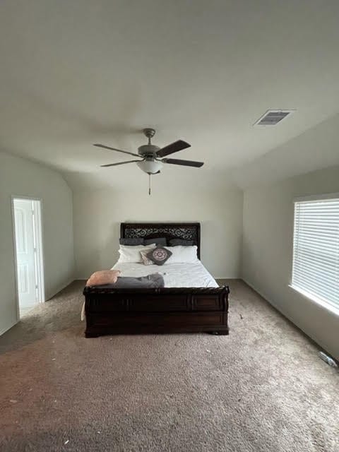 carpeted bedroom with lofted ceiling and ceiling fan