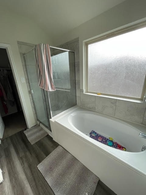 bathroom featuring hardwood / wood-style flooring and independent shower and bath