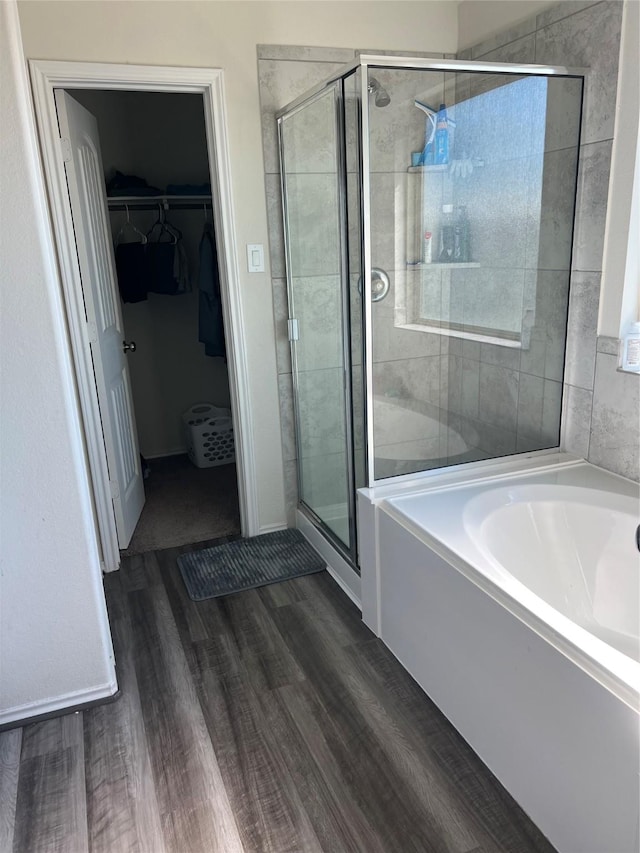 bathroom featuring independent shower and bath and wood-type flooring