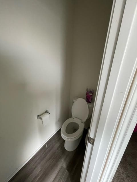 bathroom featuring hardwood / wood-style floors and toilet