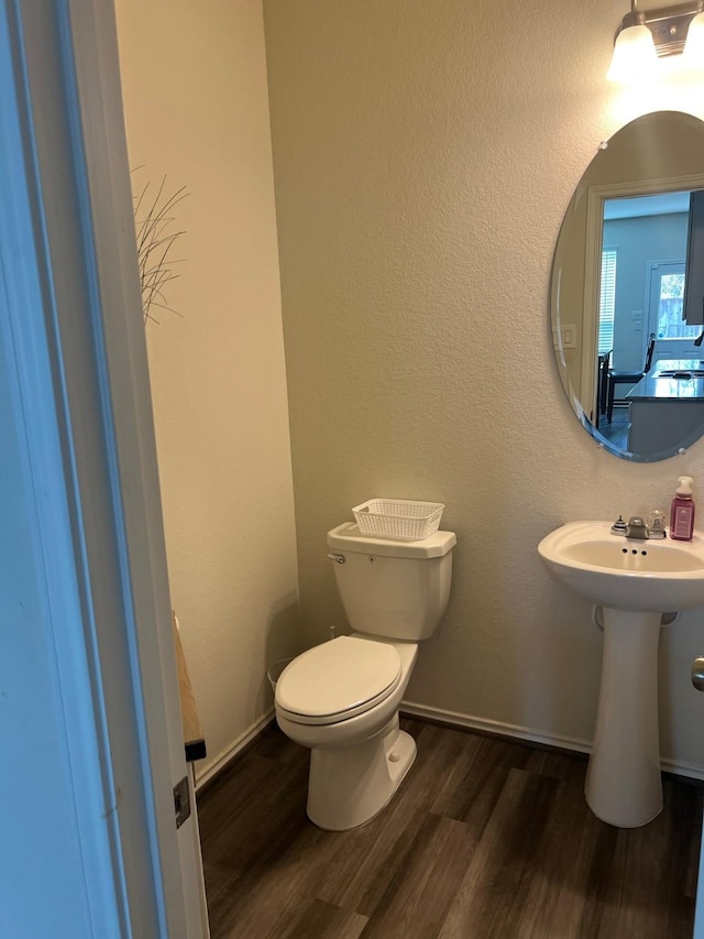 bathroom with sink, toilet, and wood-type flooring