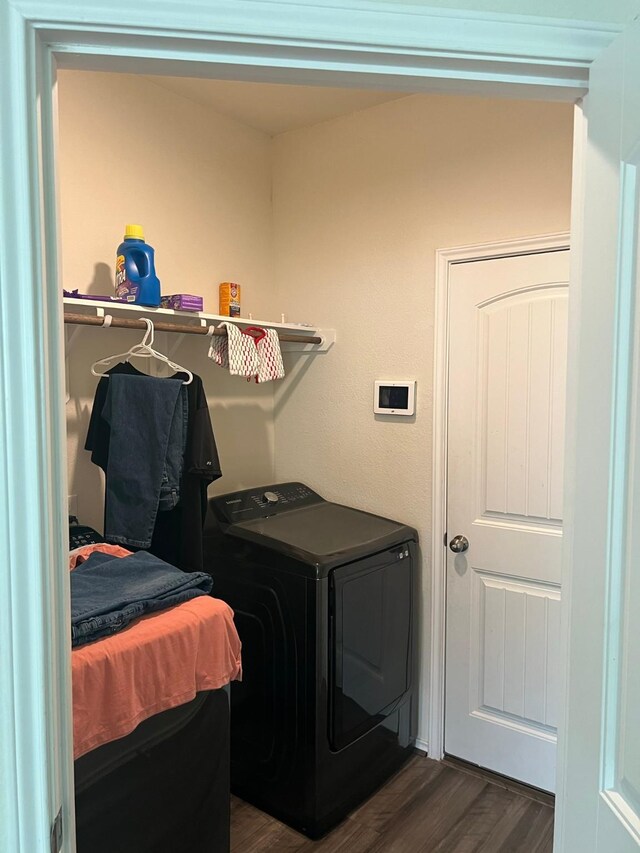 laundry area featuring washer / clothes dryer and dark hardwood / wood-style floors