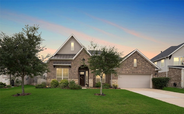 view of front of house featuring a yard and a garage