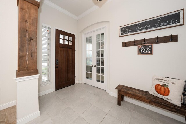 tiled foyer entrance with crown molding and french doors