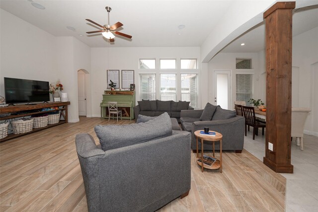 living room with ceiling fan, light hardwood / wood-style floors, and decorative columns