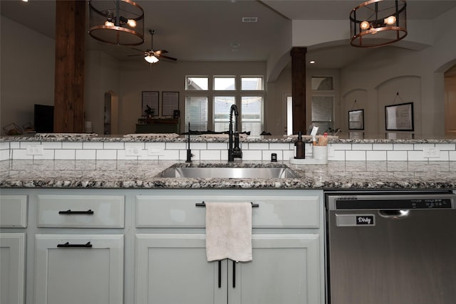 kitchen featuring ceiling fan, dishwasher, light stone countertops, sink, and white cabinets