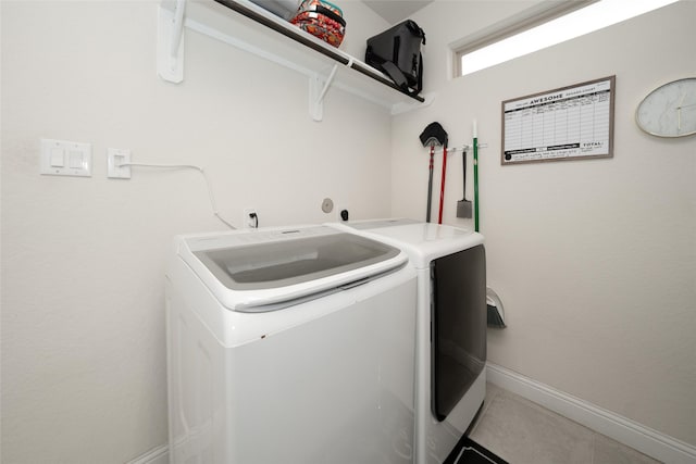 clothes washing area with separate washer and dryer