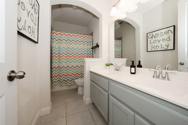 bathroom featuring tile patterned floors, vanity, a shower with shower curtain, and toilet