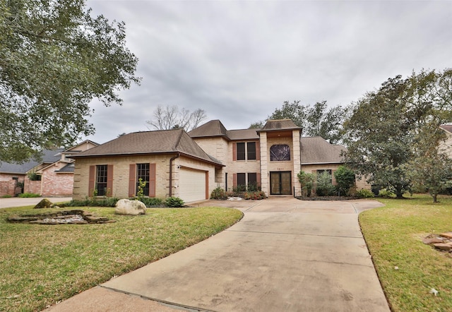 view of front of house with a garage and a front lawn