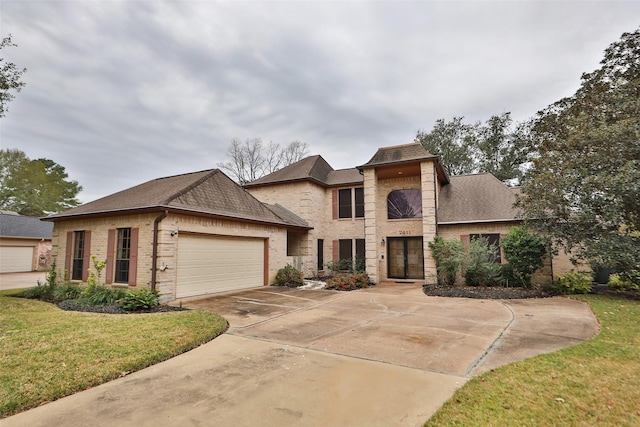 view of front of property with a garage and a front lawn