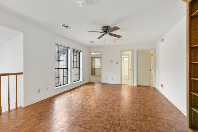 unfurnished room with ceiling fan and light parquet floors