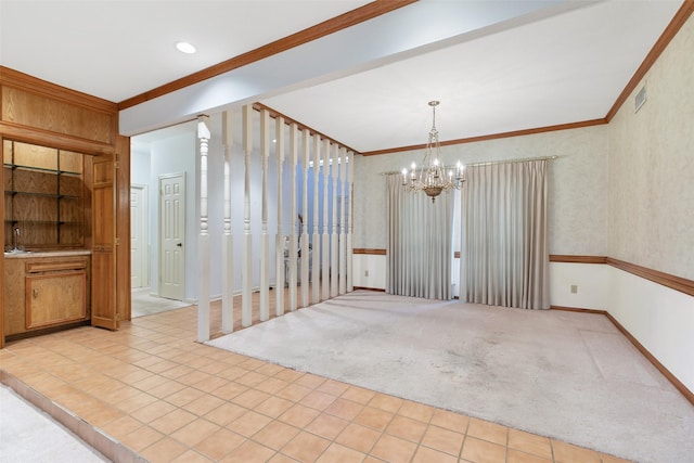 unfurnished dining area with light colored carpet, crown molding, and a chandelier