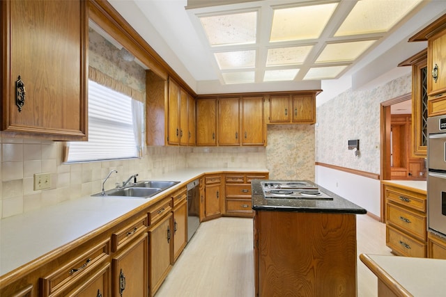 kitchen with sink, stainless steel gas cooktop, tasteful backsplash, and black dishwasher