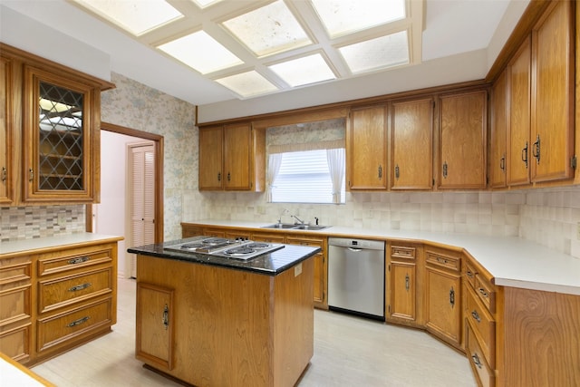 kitchen with sink, stainless steel appliances, a center island, and backsplash