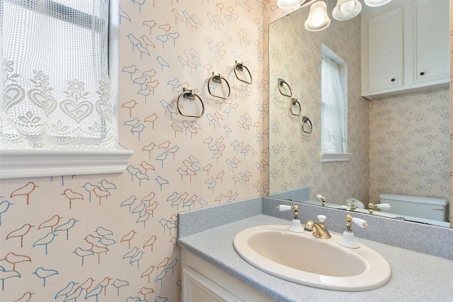 bathroom featuring toilet and vanity