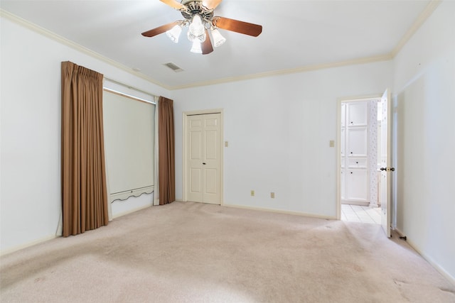 unfurnished bedroom featuring light colored carpet, ceiling fan, and ornamental molding