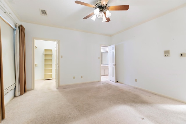 unfurnished room with ornamental molding, ceiling fan, and light colored carpet