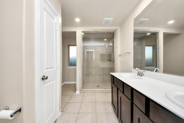 bathroom with vanity, a shower with shower door, and tile patterned flooring