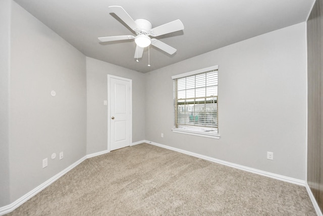 carpeted empty room with ceiling fan