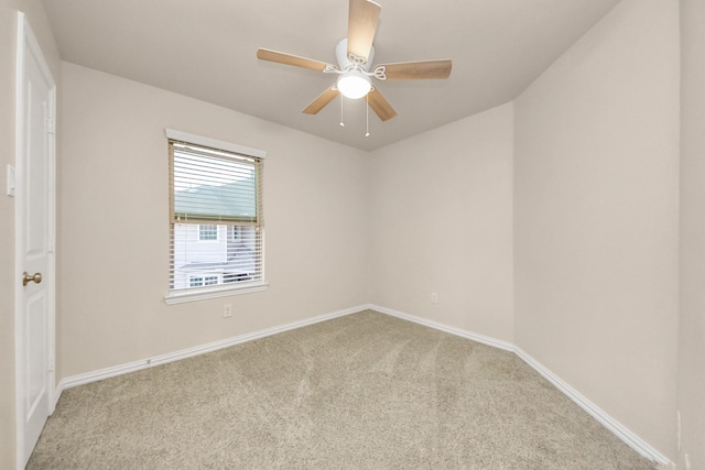 spare room with ceiling fan and light carpet