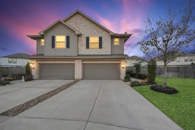 view of front of home with a garage and a yard