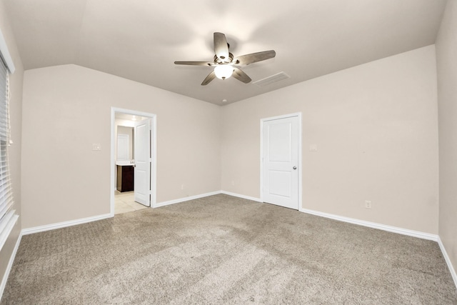 carpeted spare room with lofted ceiling and ceiling fan