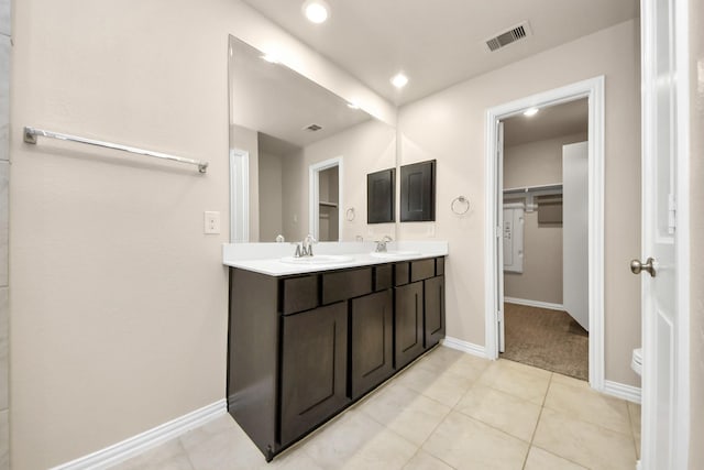 bathroom with vanity, toilet, and tile patterned flooring