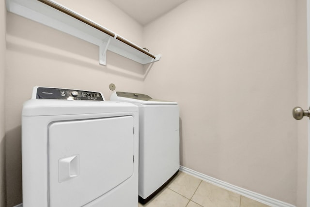 laundry area featuring washing machine and dryer and light tile patterned floors