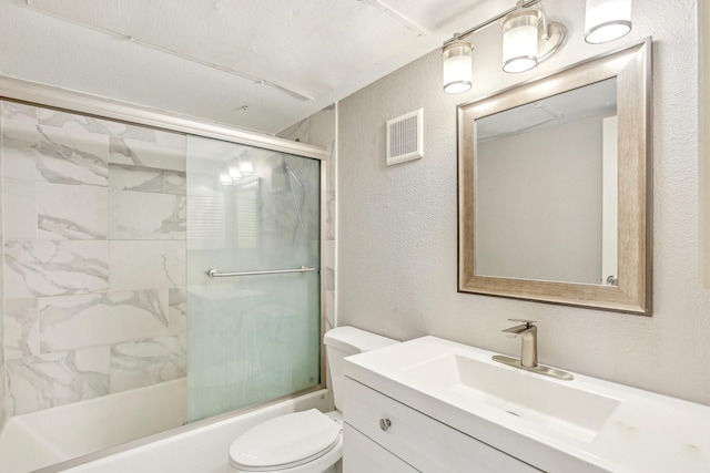 full bath featuring visible vents, a textured wall, toilet, shower / bath combination with glass door, and vanity