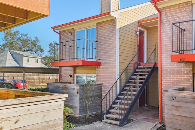 doorway to property with brick siding and a chimney