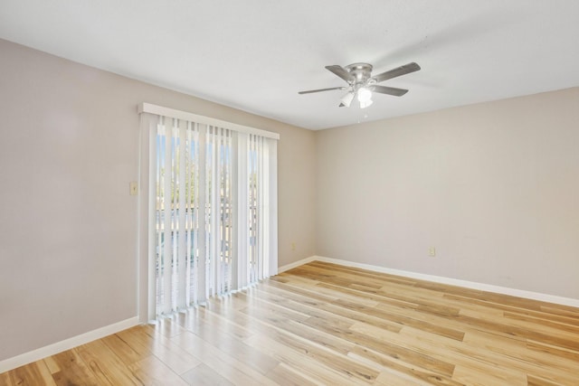 empty room featuring a ceiling fan, light wood-type flooring, and baseboards