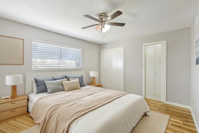 bedroom with a ceiling fan, baseboards, and light wood finished floors