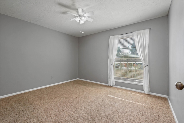 spare room featuring carpet flooring, ceiling fan, and a textured ceiling