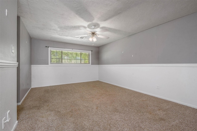 empty room featuring carpet flooring, a textured ceiling, and ceiling fan