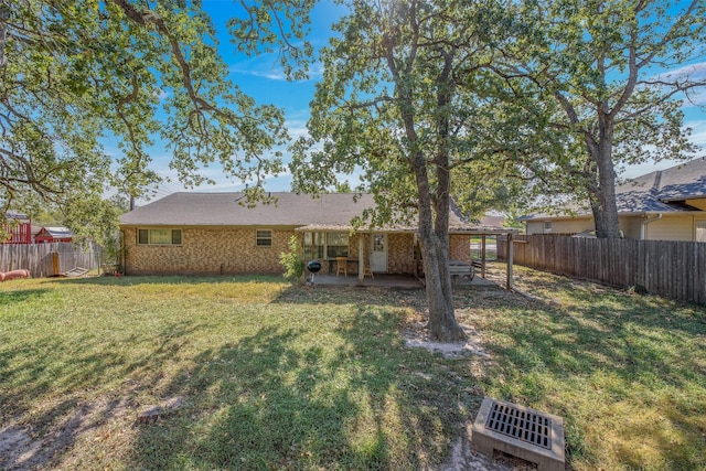 back of property featuring a patio area and a lawn