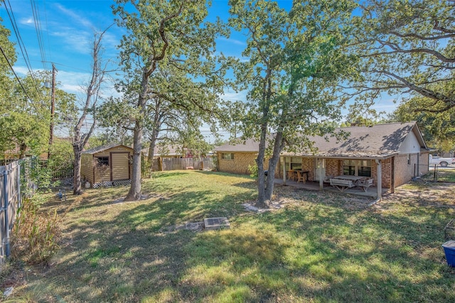 view of yard with a shed and a patio area