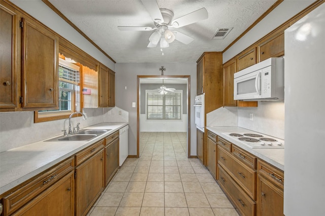 kitchen with ceiling fan, sink, pendant lighting, a textured ceiling, and white appliances