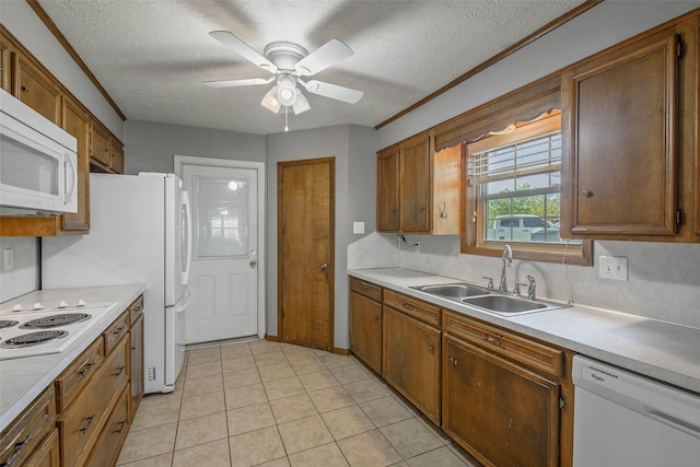 kitchen featuring a textured ceiling, ceiling fan, white appliances, and sink