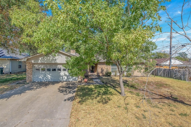 view of front of home with a front yard and a garage