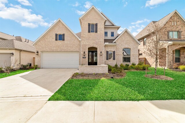 view of front facade with a front lawn and a garage