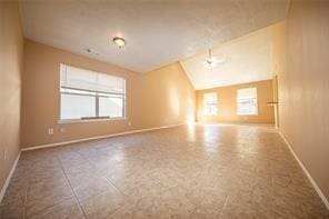 unfurnished room featuring lofted ceiling