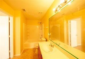 bathroom with vanity and shower / bathing tub combination