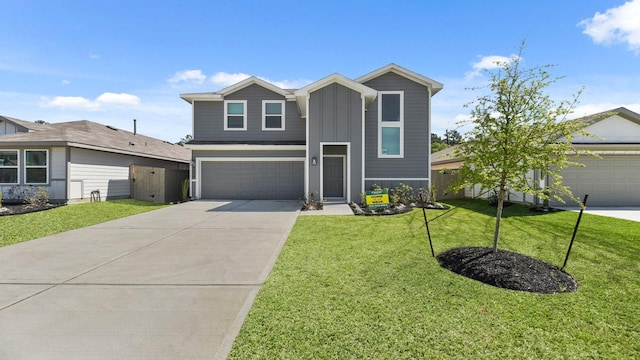 view of front of house with concrete driveway, a front yard, board and batten siding, and an attached garage